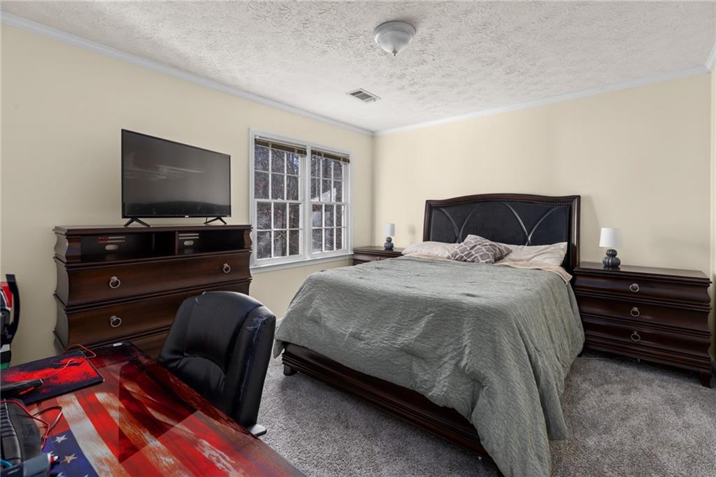 705 Springview Court Roswell, GA 30076 - Photo 53 of 79 a bedroom with a bed and flat screen tv