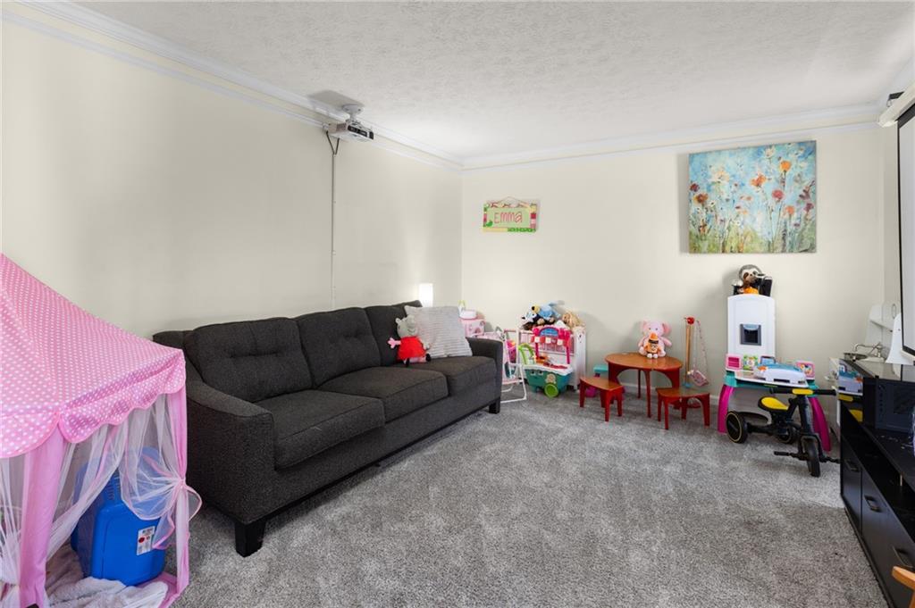 705 Springview Court Roswell, GA 30076 - Photo 6 of 79 a living room with furniture and a baby crib