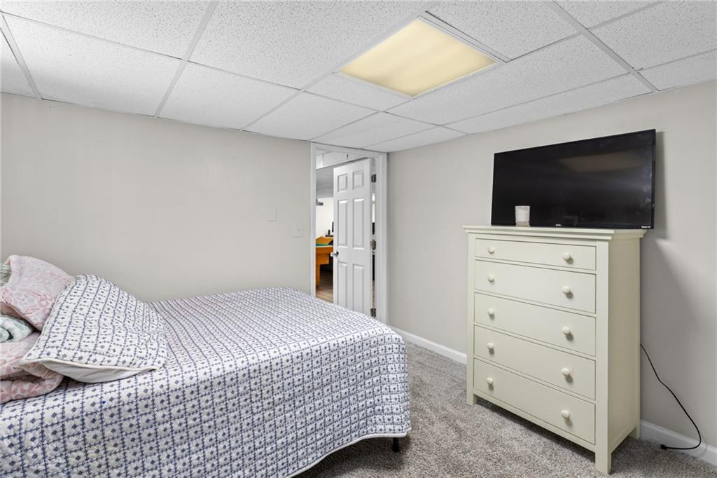 705 Springview Court Roswell, GA 30076 - Photo 62 of 79 a bedroom with a bed and a flat screen tv