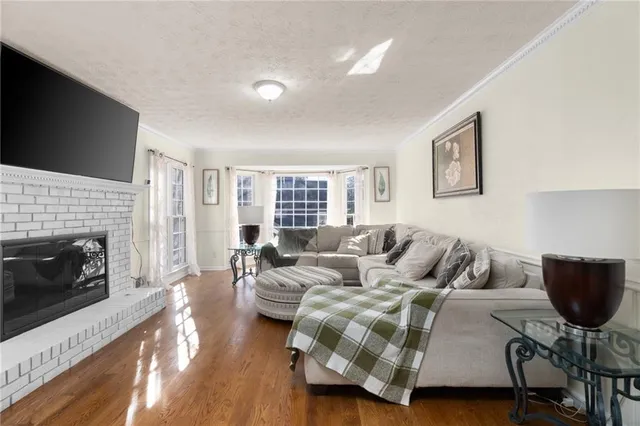 a living room with a fireplace and a floor to ceiling window