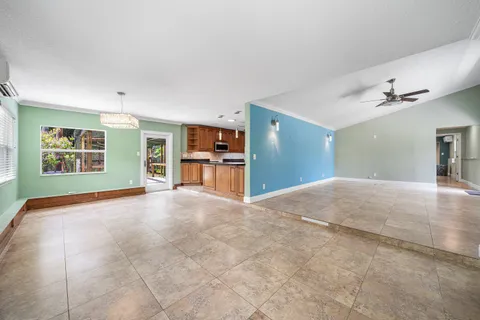 a view of kitchen with furniture and refrigerator
