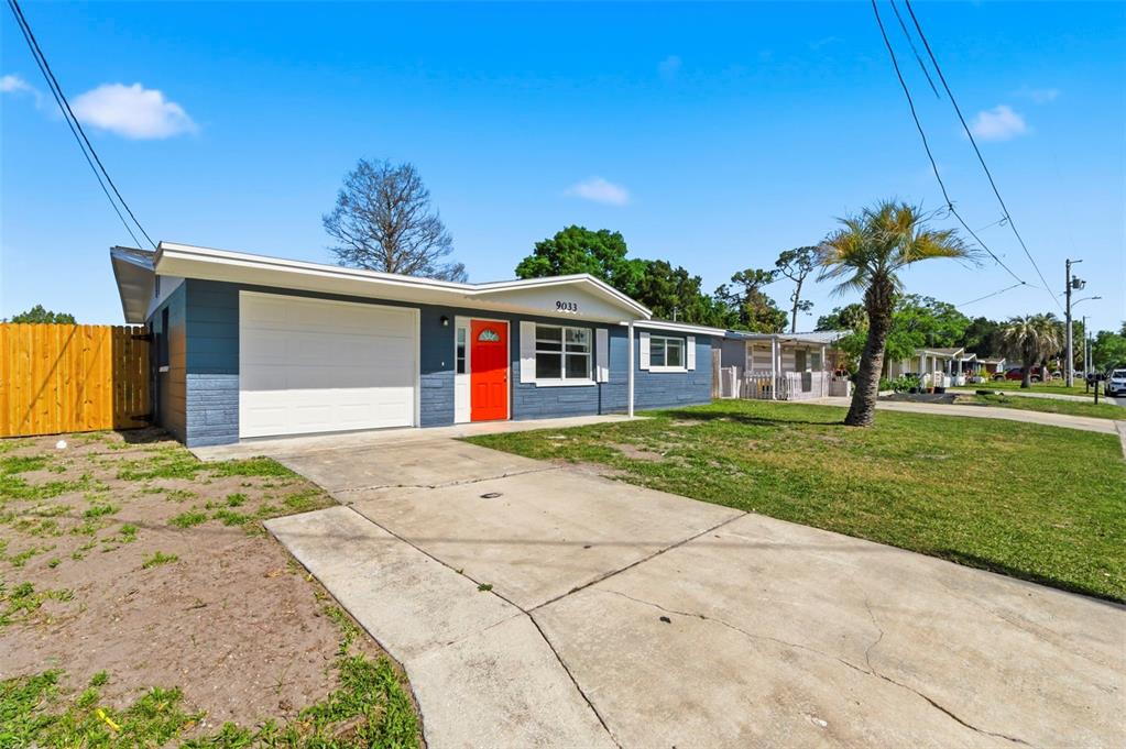 9033 Pegasus Avenue Port Richey, FL 34668 - Photo 3 of 56 a front view of a house with a yard