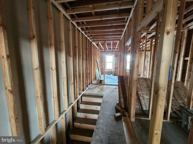 a view of a room with lots of wooden furniture