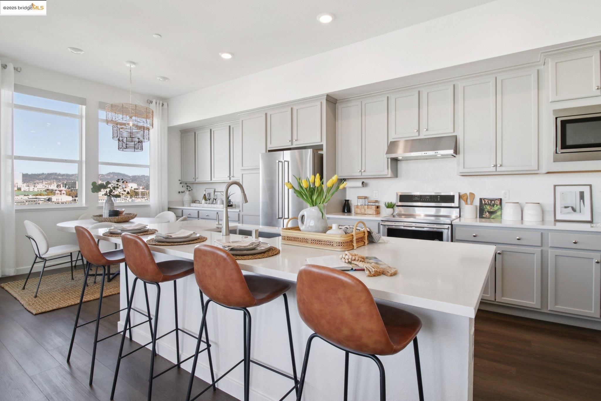 2878 5th Street Alameda, CA 94501 - Photo 16 of 56 a kitchen with stainless steel appliances kitchen island granite countertop a dining table chairs and granite counter tops
