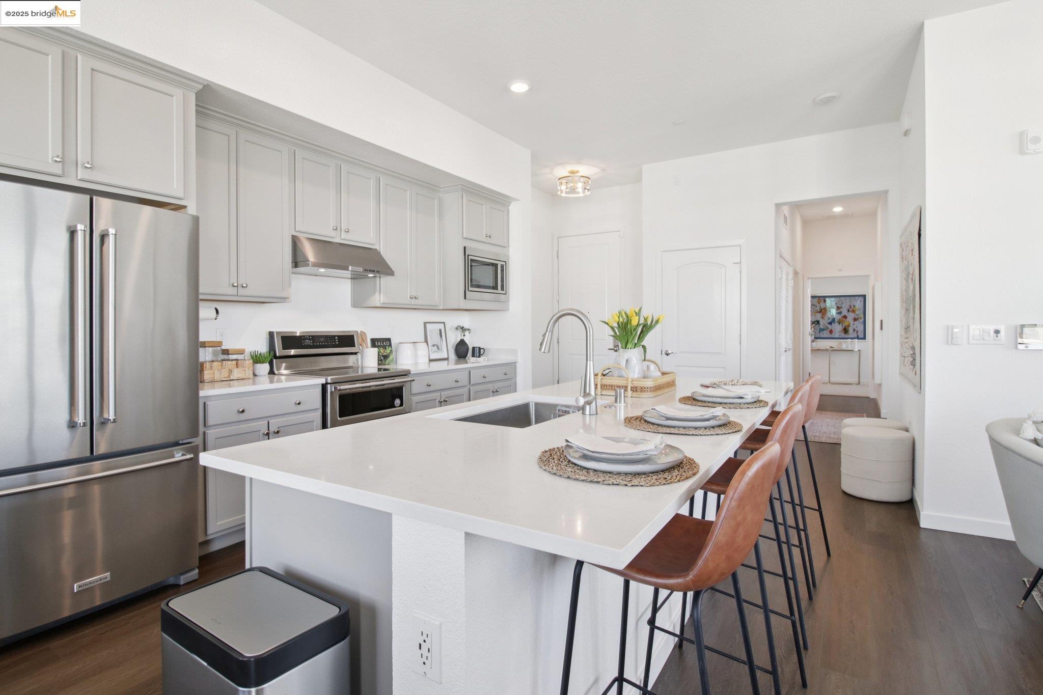 2878 5th Street Alameda, CA 94501 - Photo 17 of 56 a kitchen with stainless steel appliances granite countertop a dining table chairs and a refrigerator
