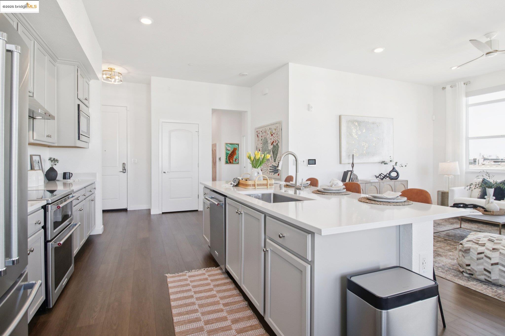 2878 5th Street Alameda, CA 94501 - Photo 18 of 56 a large white kitchen with a sink a stove and a refrigerator
