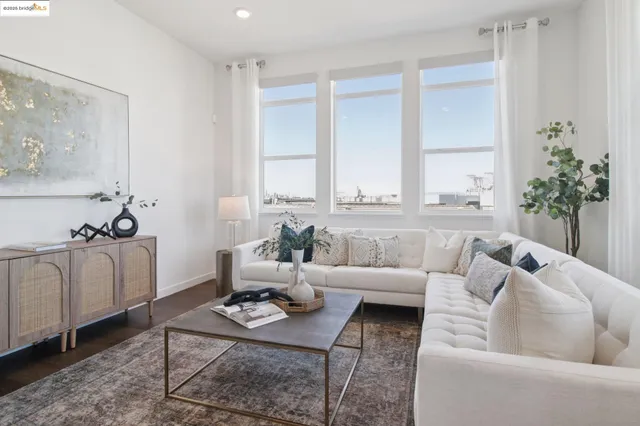 a dining room with furniture a rug and wooden floor