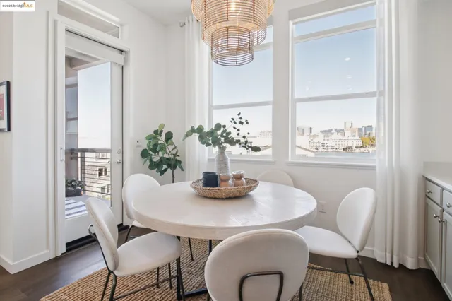 a kitchen with stainless steel appliances kitchen island granite countertop a dining table chairs and granite counter tops