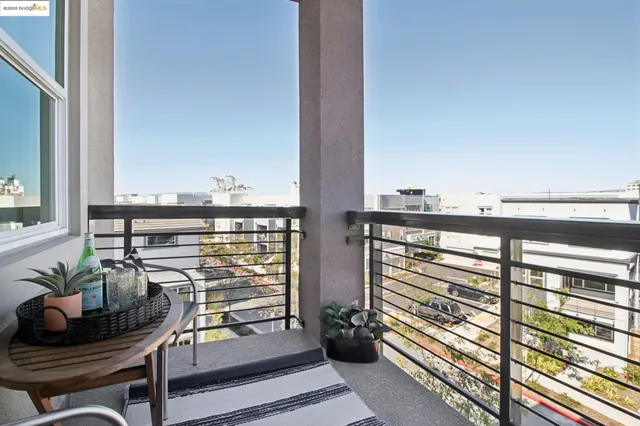 a kitchen with stainless steel appliances granite countertop a dining table chairs and a refrigerator