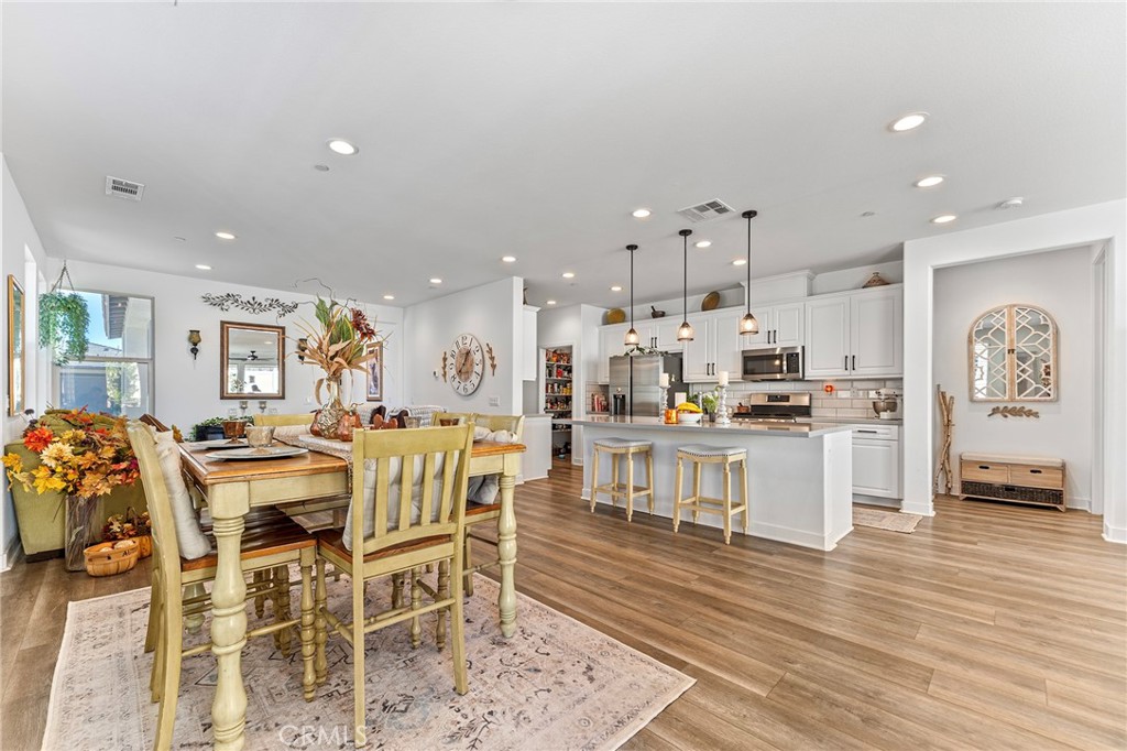 1656 Spring Run Lane Beaumont, CA 92223 - Photo 13 of 40 a large kitchen with a table and chairs