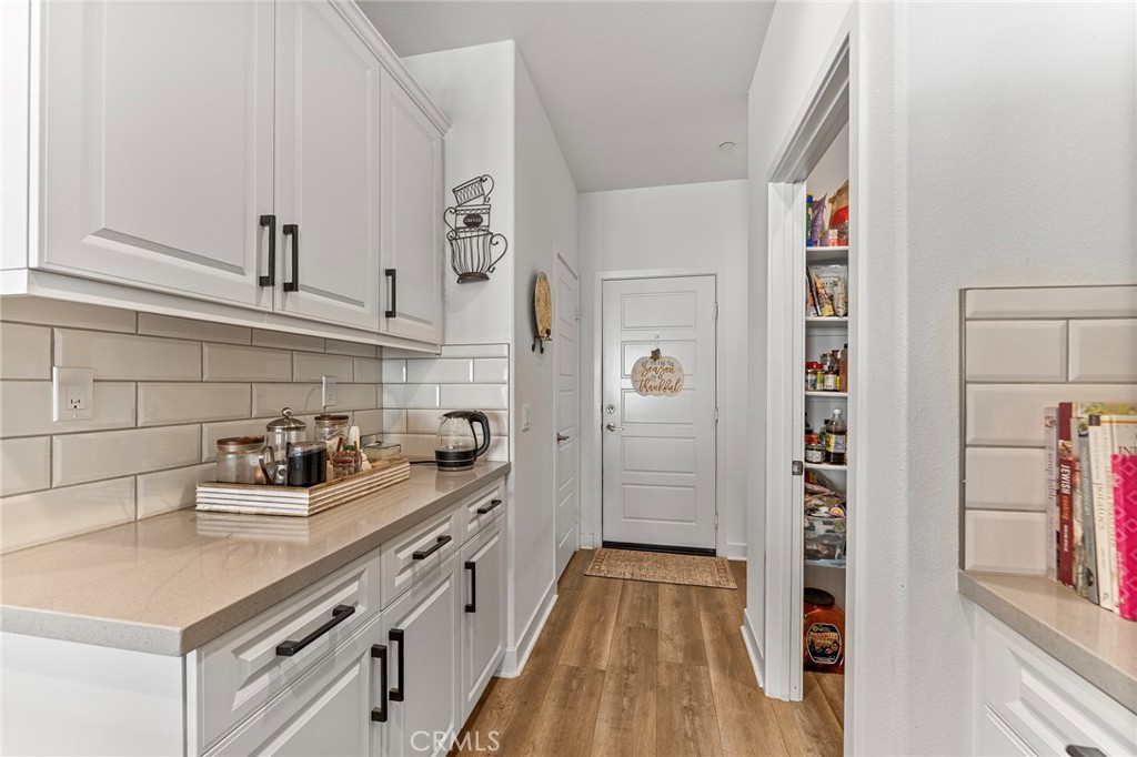 1656 Spring Run Lane Beaumont, CA 92223 - Photo 20 of 40 a kitchen with white cabinets and sink