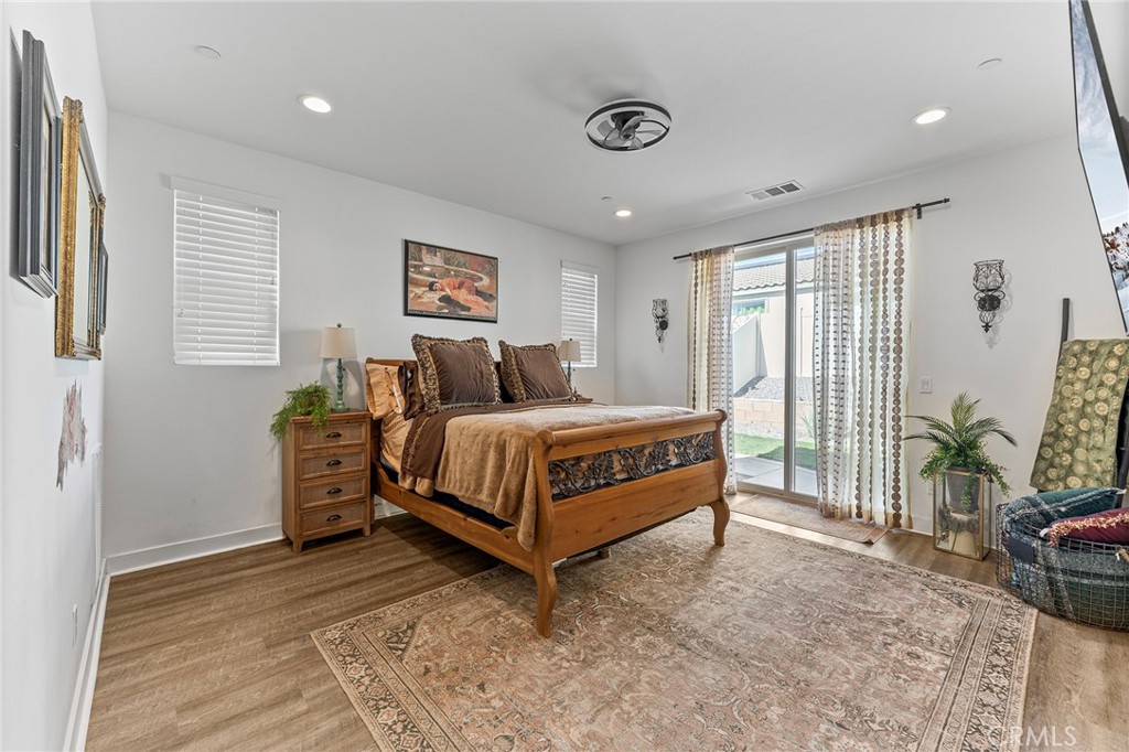 1656 Spring Run Lane Beaumont, CA 92223 - Photo 22 of 40 a bedroom with a bed and a potted plant