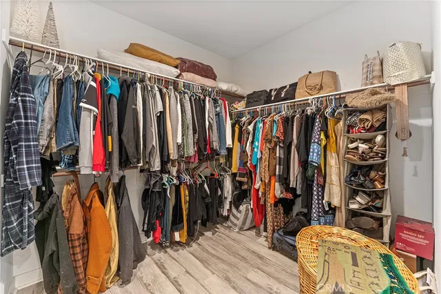 a view of walk in closet with clothes