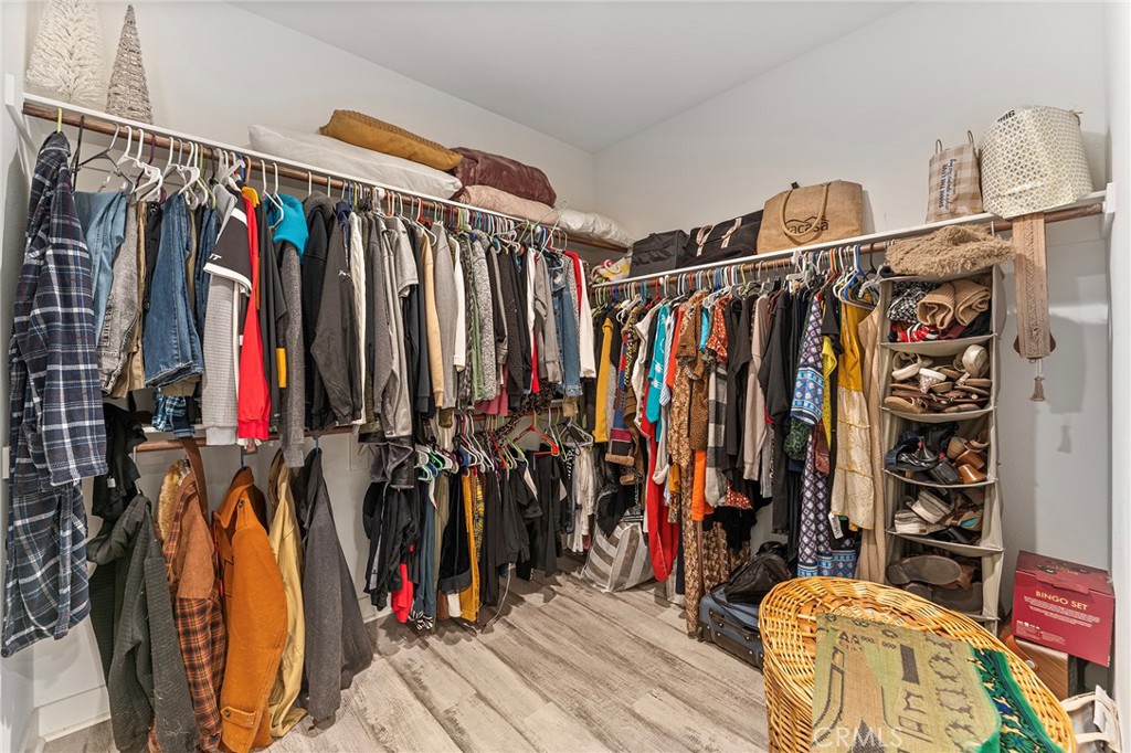 1656 Spring Run Lane Beaumont, CA 92223 - Photo 26 of 40 a view of walk in closet with clothes