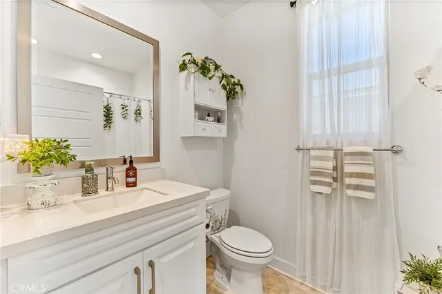 a bathroom with a sink toilet and vanity