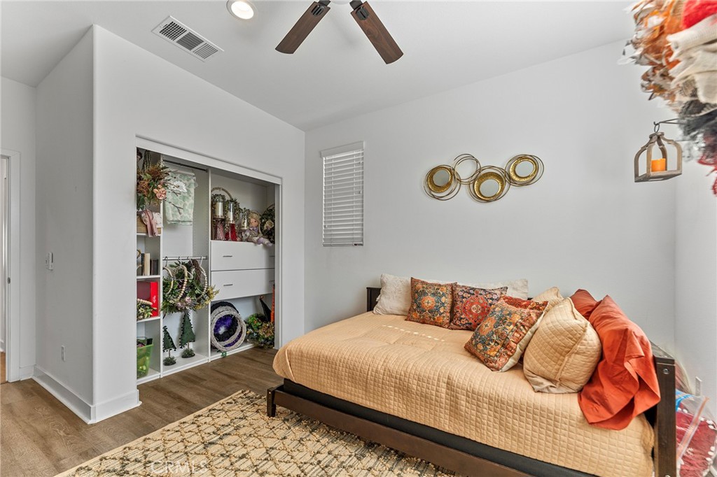 1656 Spring Run Lane Beaumont, CA 92223 - Photo 6 of 40 a bedroom with a bed and a table in it