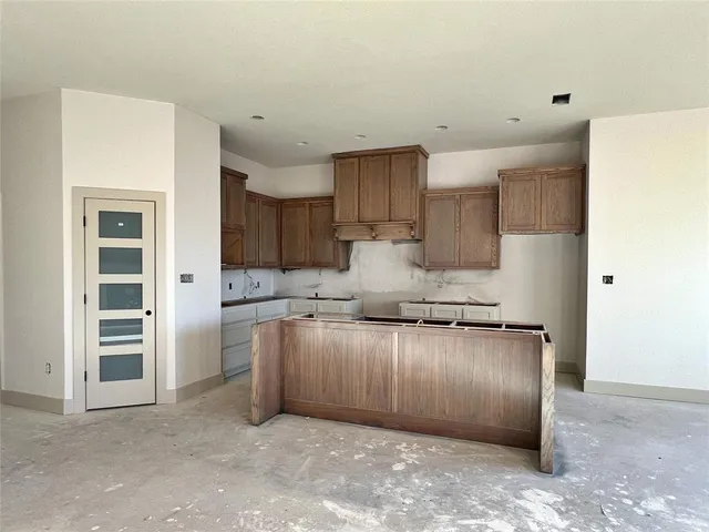 a kitchen with stainless steel appliances granite countertop a refrigerator and a stove