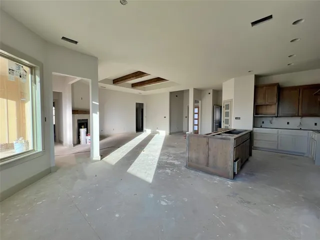 a large space with a large window and stainless steel appliances