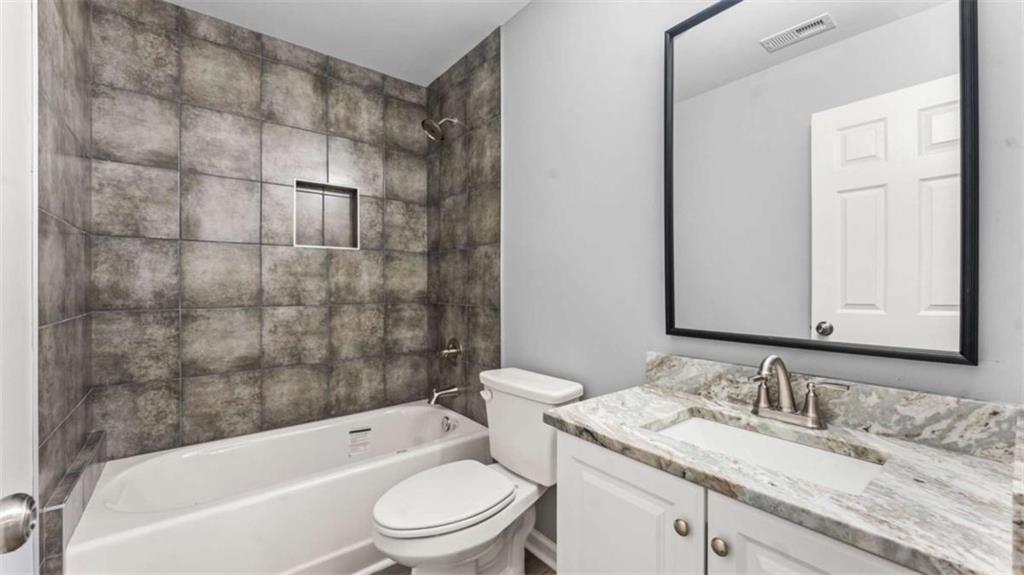 804 Blanche Road Cedartown, GA 30125 - Photo 14 of 24 a bathroom with a granite countertop sink toilet and shower