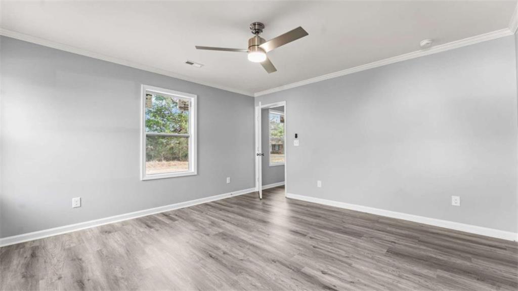 804 Blanche Road Cedartown, GA 30125 - Photo 18 of 24 an empty room with wooden floor and windows