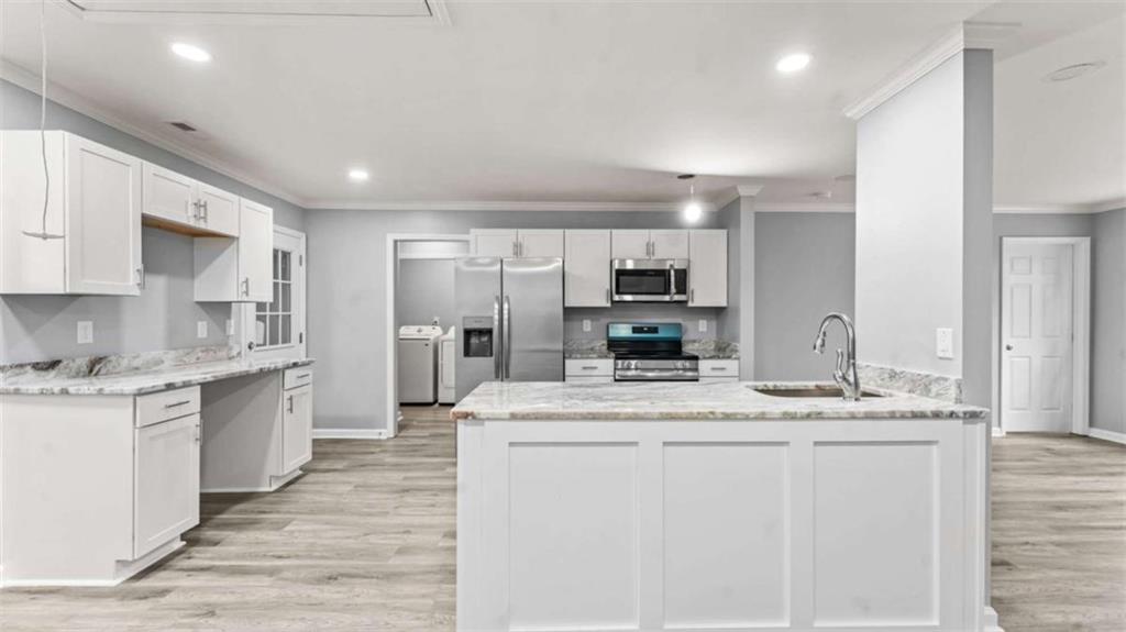 804 Blanche Road Cedartown, GA 30125 - Photo 3 of 24 a large kitchen with stainless steel appliances kitchen island granite countertop a stove a sink a refrigerator and white cabinets with wooden floor