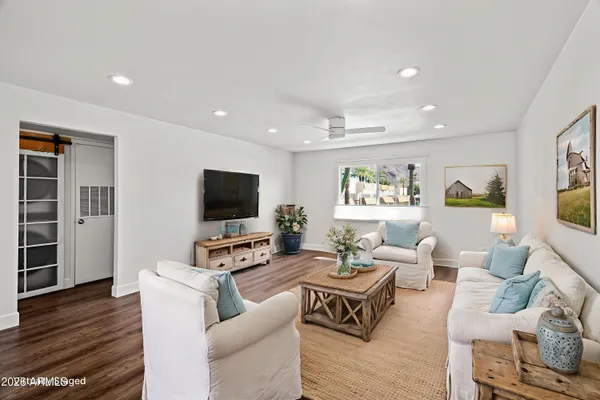 an empty room with wooden floor and a window