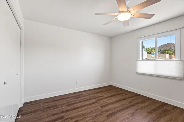 a bathroom with a granite countertop sink a toilet and shower