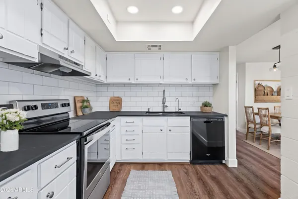 a kitchen with a sink stove and cabinets