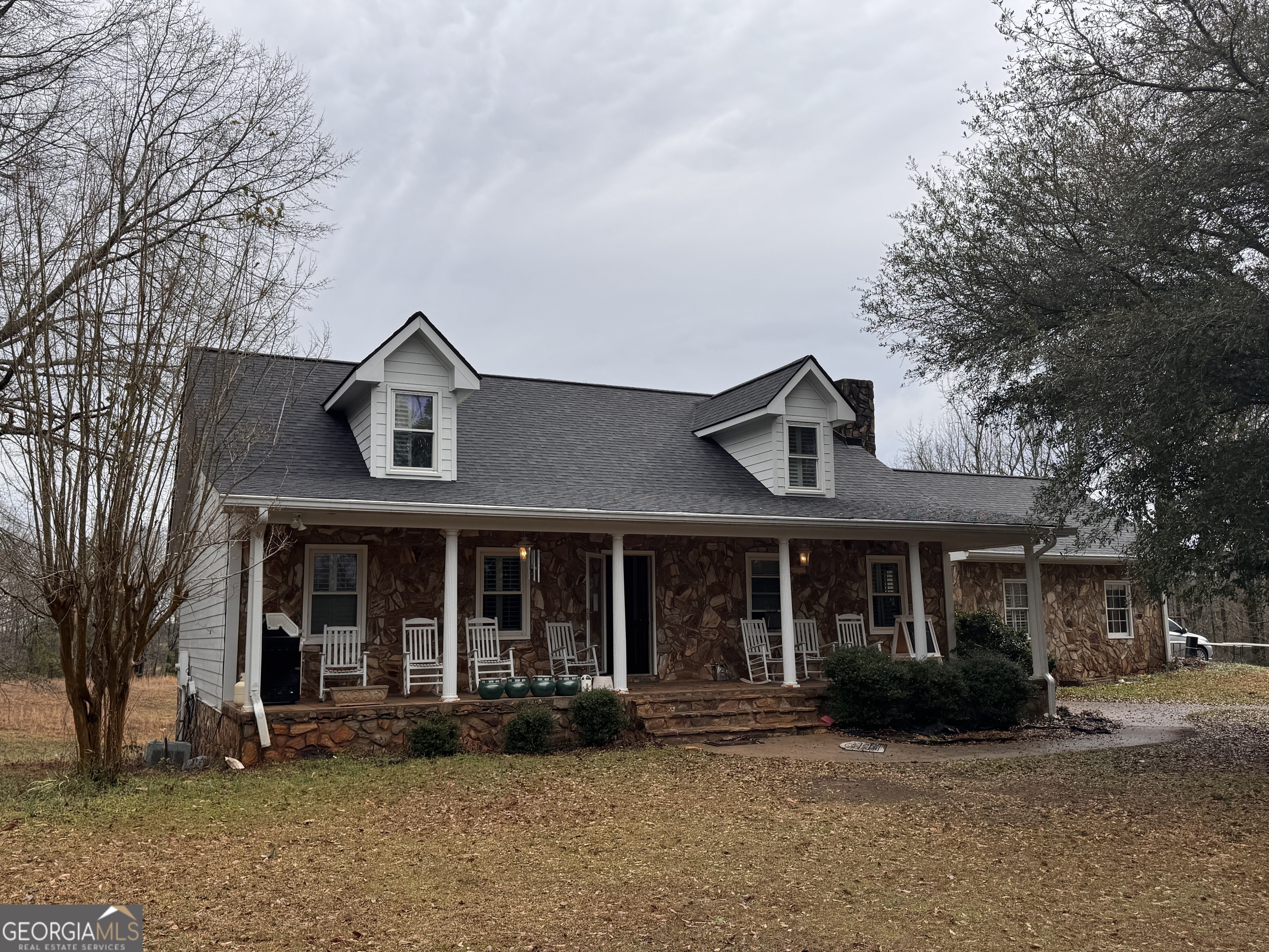 5382 Hawkins Academy Road Social Circle, GA 30025 - Photo 1 of 2 a front view of a house with a garden and porch