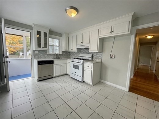 59 Desoto Road, Unit 2 Boston, MA 02132 - Photo 5 of 13 a kitchen with stainless steel appliances granite countertop a stove a sink and a refrigerator