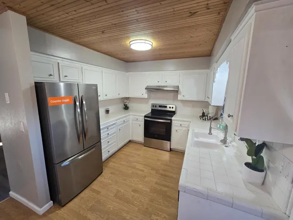 a kitchen with stainless steel appliances a refrigerator and a sink