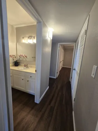 a view of hallway with sink and wooden floor