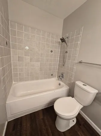 a bathroom with a toilet a sink and bathtub