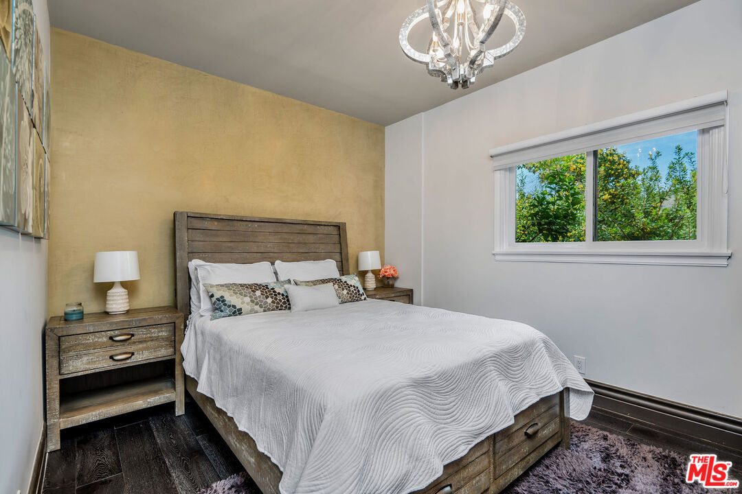204 Bell Cyn Road Bell Canyon, CA 91307 - Photo 19 of 74 a bedroom with a bed and a chandelier
