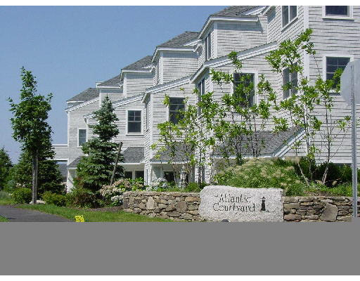 50 Atlantic House Road, Unit 3A Hull, MA 02045 - Photo 1 of 1 a view of a white house with a yard and potted plants
