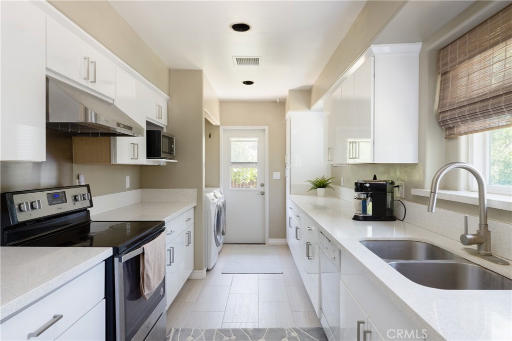 620 Beverly Drive Arcadia, CA 91006 - Photo 11 of 29 a kitchen with kitchen island granite countertop a sink and white cabinets