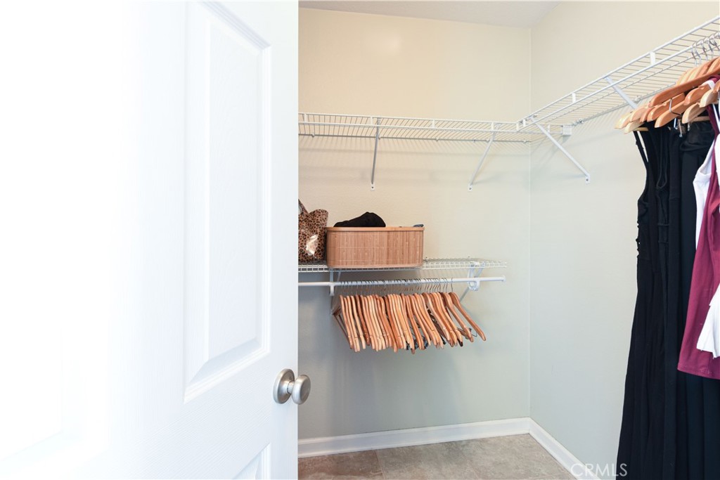 35630 Bryce Road Winchester, CA 92596 - Photo 19 of 32 a view of walk in closet with clothes and shoes