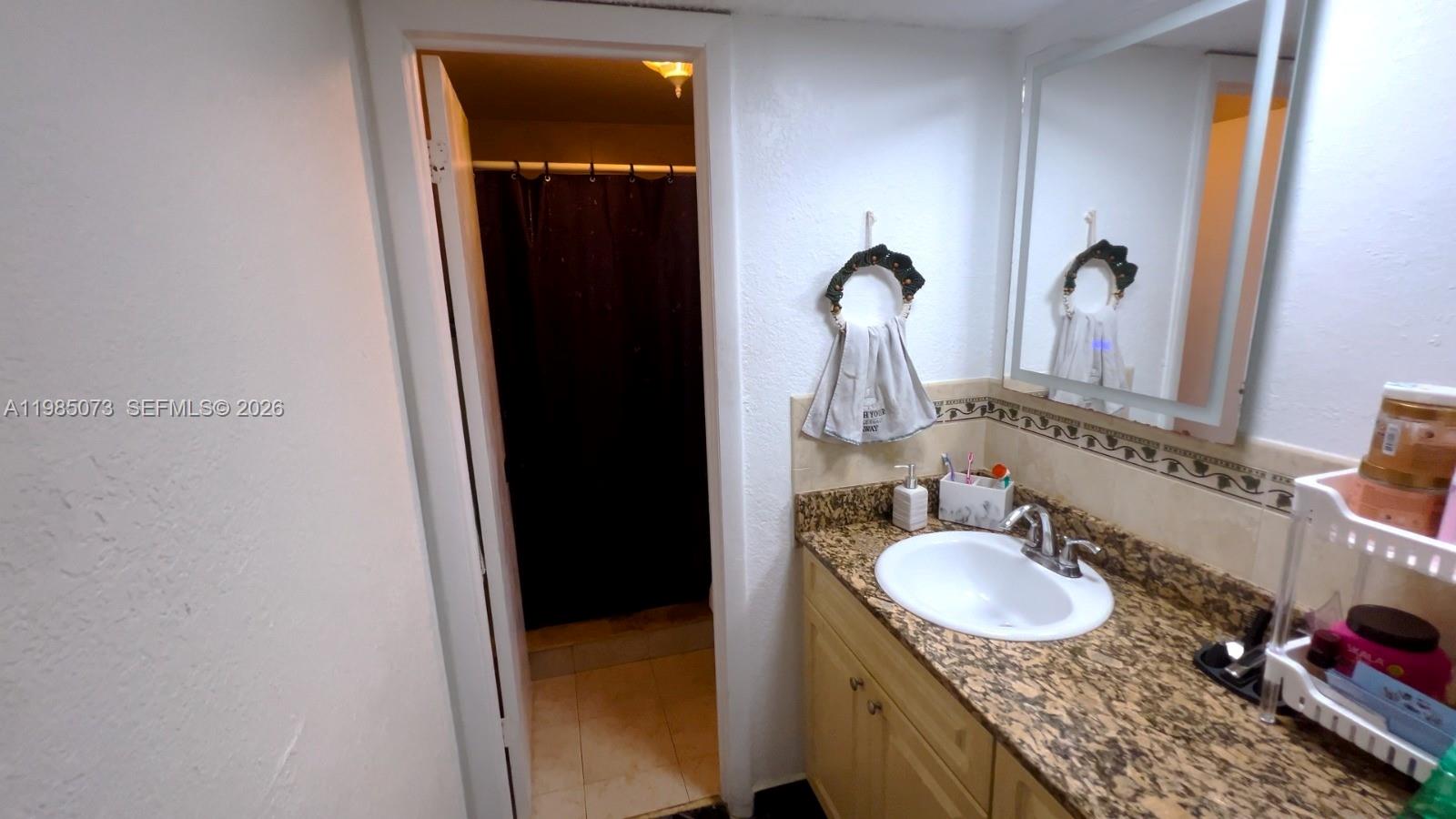 1900 West 68th Street, Unit D207 Hialeah, FL 33014 - Photo 8 of 33 a bathroom with a sink and mirror