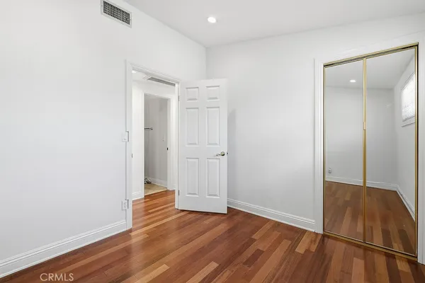 an empty room with wooden floor