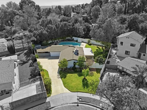 an aerial view of a house with garden space and street view