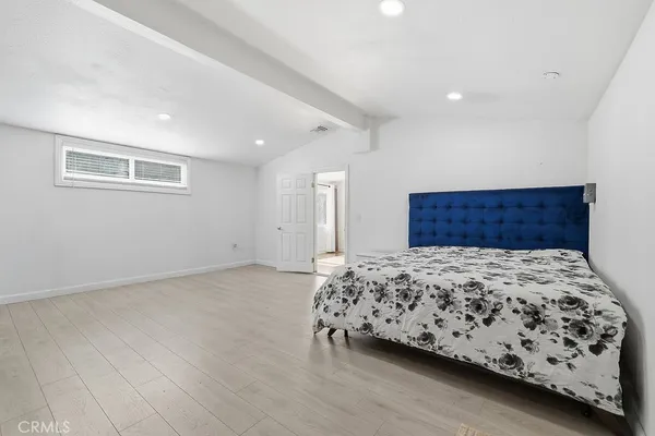 a bedroom with a large bed and a dresser