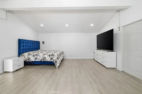 a room with a bed and a flat screen tv
