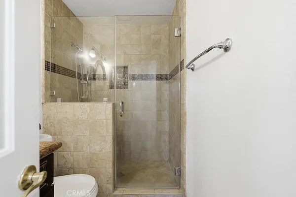 a bathroom with a shower and toilet