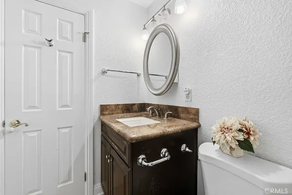 a bathroom with a sink vanity and a mirror