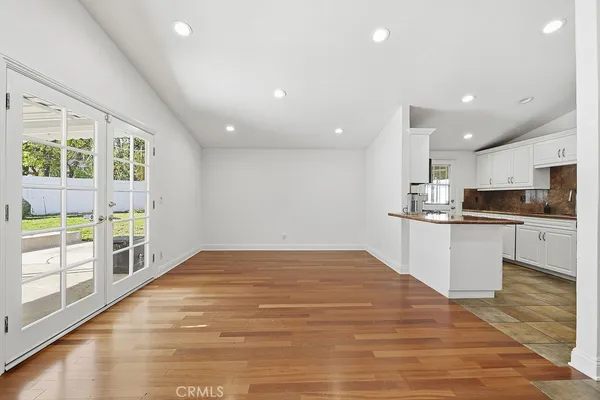 a view of kitchen with wooden floor and electronic appliances