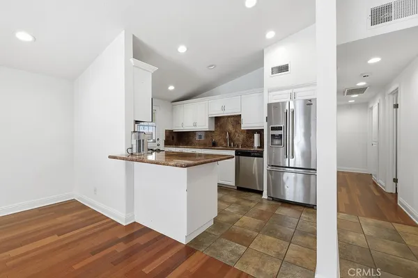 a kitchen with a refrigerator a sink and a stove
