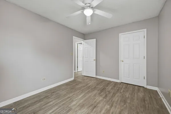 a view of an empty room with wooden floor