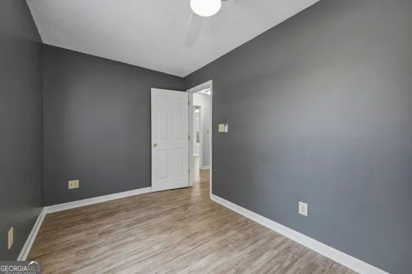 a view of an empty room with wooden floor