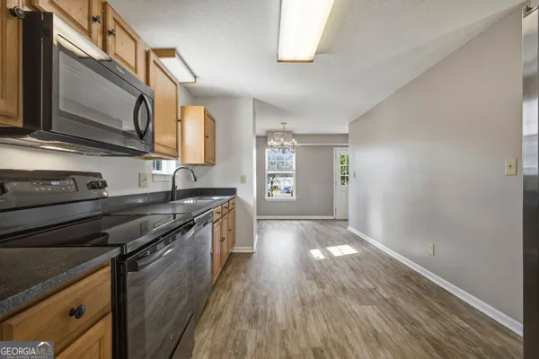 a kitchen with granite countertop a stove and a sink