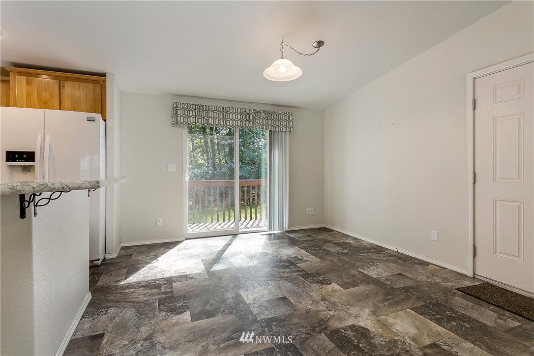 7592 Woodland Road Ferndale, WA 98248 - Photo 14 of 38 a view of an empty room with wooden floor and a window
